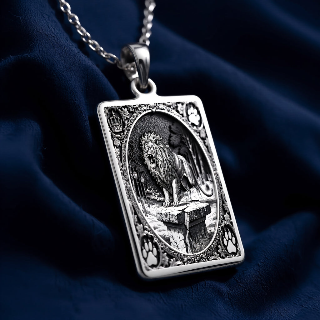 Silver pendant featuring a detailed design of a lion with a crown motif, presented in a flat view. The pendant has a polished surface finish and is shown against a white background.