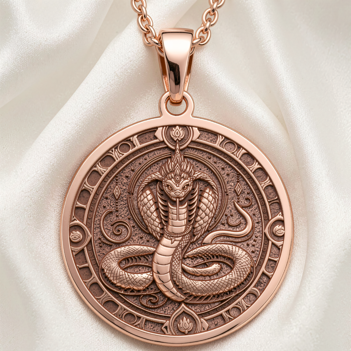 Naga Serpent Talisman Necklace in 14K Rose Gold Plated. Front view shows engraved coiled serpent and lotus motifs.
