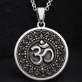 Silver circular pendant featuring an ornate border design around the central Om motif. The pendant is suspended from a silver chain, presented in a clear, frontal view.