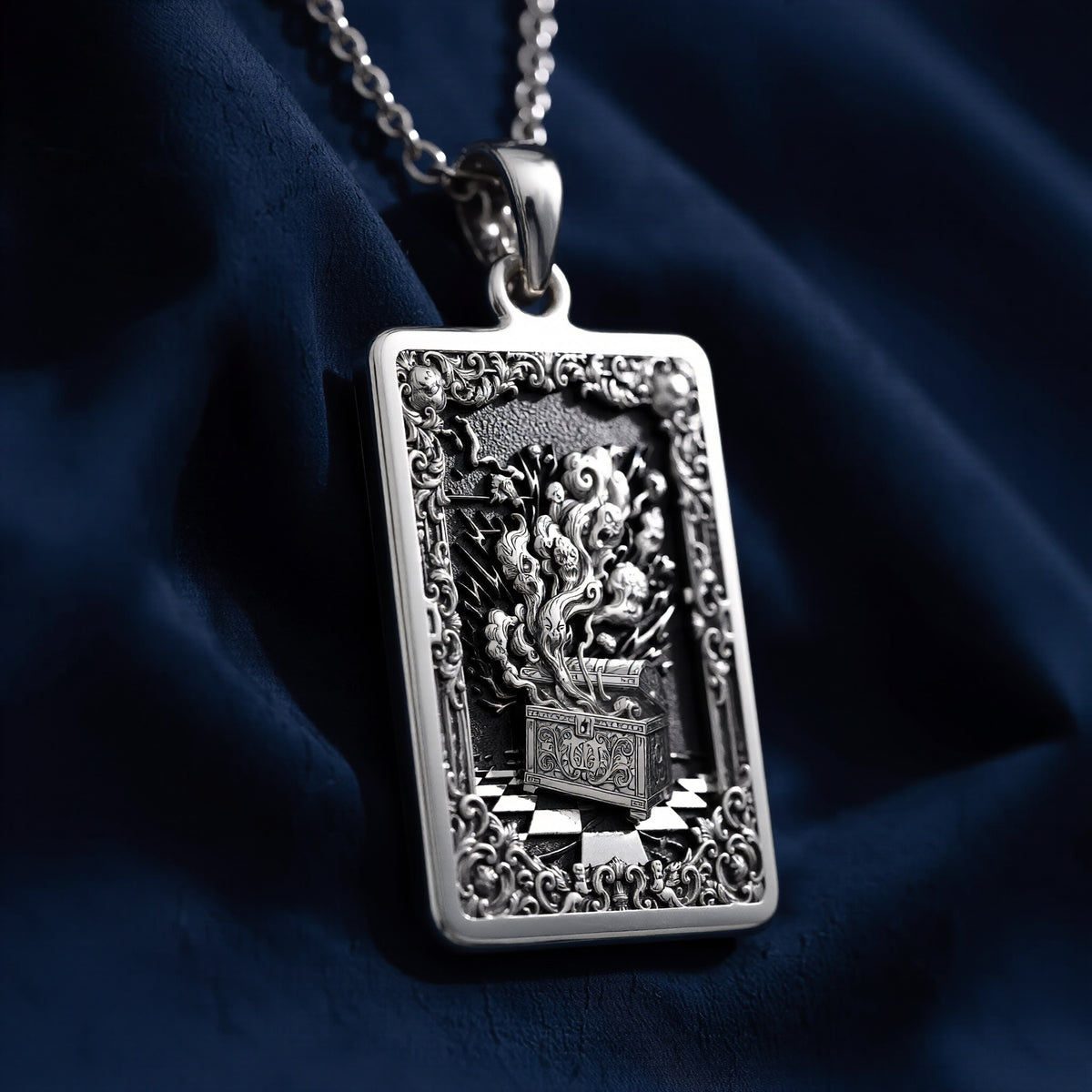 Silver rectangular pendant necklace featuring an ornate, detailed frame design with intricate scrollwork. The pendant is attached to a silver chain and displayed among faceted gemstones. - View 6