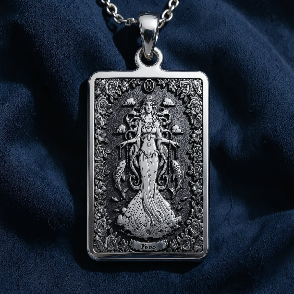 Silver pendant featuring a detailed design of the Pisces constellation, shown from the front view. The pendant has an intricate, textured surface finish and is attached to a delicate silver chain.