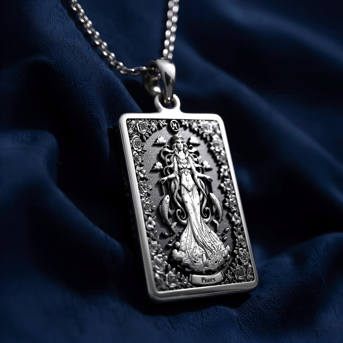 Silver plated rectangular pendant with fine detailing of a classical figure within an elaborate border. The necklace features a silver chain and is presented against a soft background. - View 6