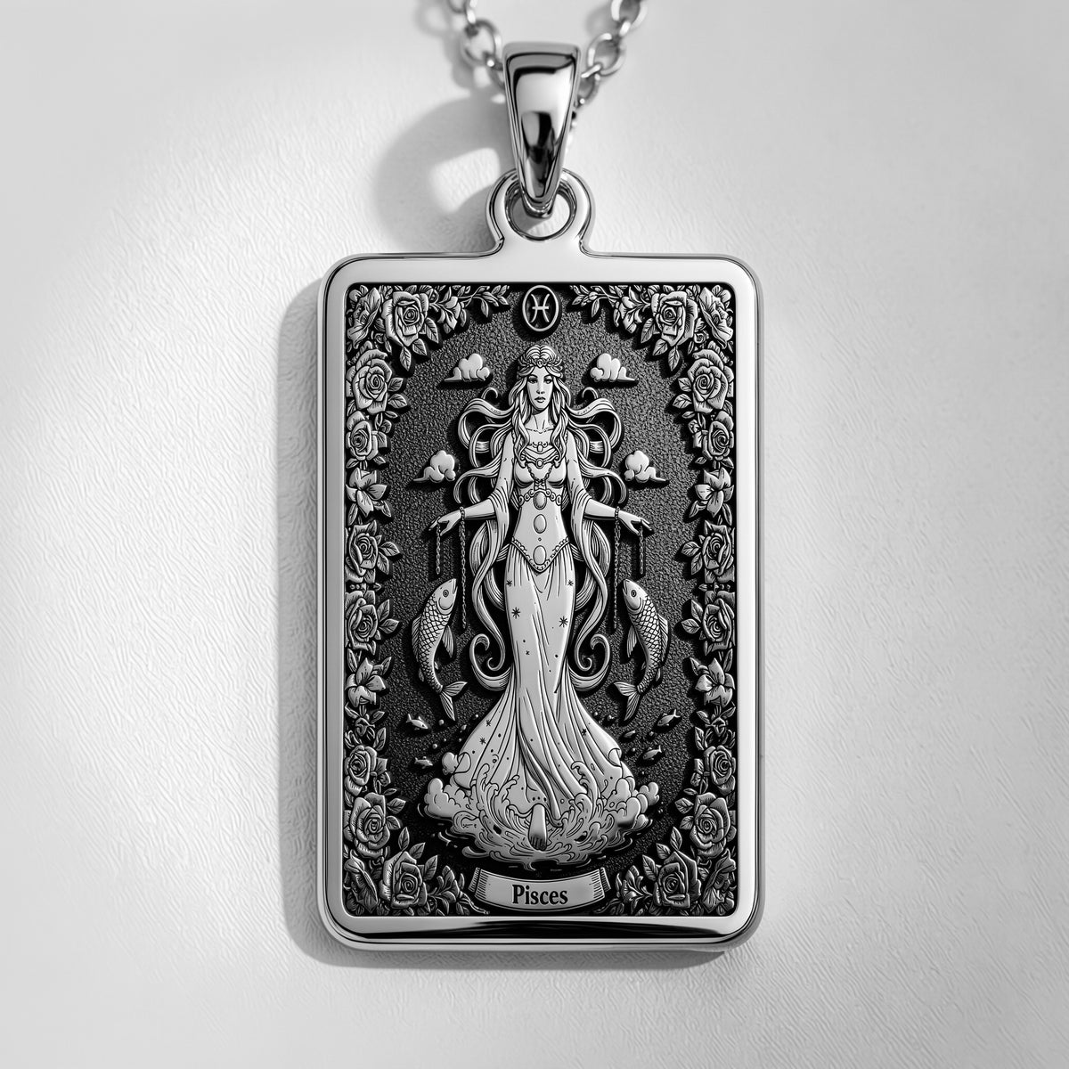 Silver plated rectangular pendant with fine detailing of a classical figure within an elaborate border. The necklace features a silver chain and is presented against a soft background.