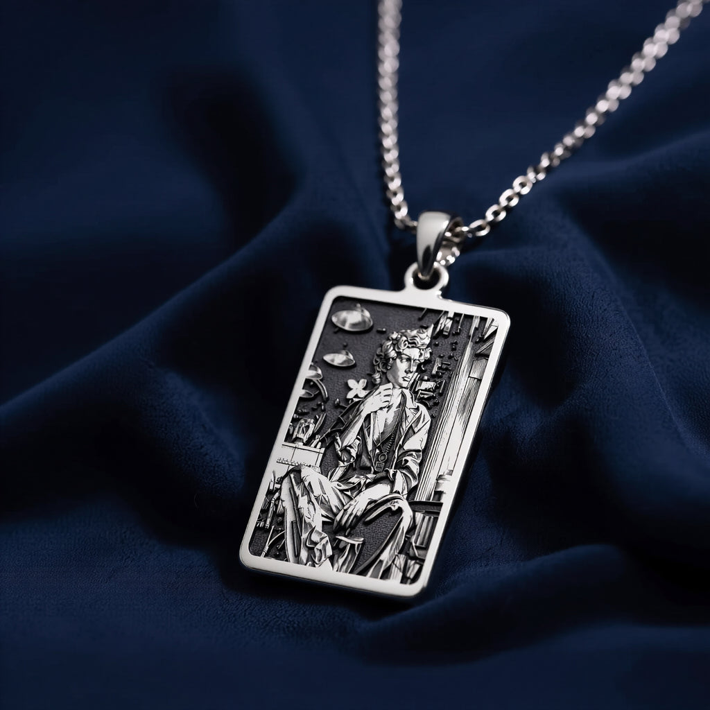 Silver rectangular pendant featuring an engraved classical design. This piece is suspended by a silver-toned chain and presented on a dark backdrop, emphasizing the detailed texture of the metal. - View 7