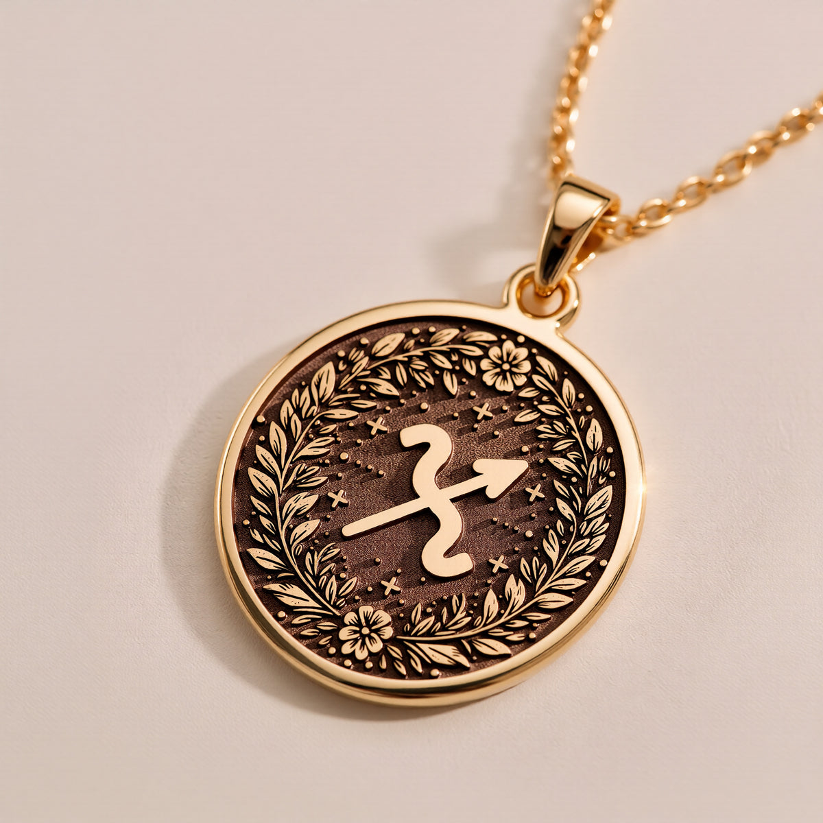 Side profile detail of the 14K solid yellow gold Sagittarius laurel wreath disc pendant highlighting coin thickness and edge finish.