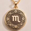 14K Solid Gold Scorpio Zodiac Medallion with Scorpio symbol (♏) and a floral wreath border. A perfect personalized gift with optional back engraving. Detailed celestial horoscope jewelry.
