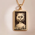 A slightly angled view of the 14K Solid Gold Scottish Fold pendant, highlighting the polished finish on the frame and the cat's distinctive folded ears.