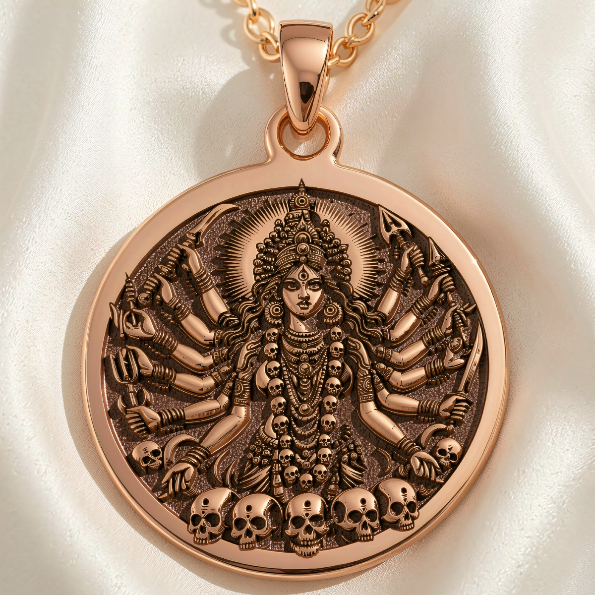Shodashi Goddess Maa Kali Shakti Pendant in 14K rose gold plated finish. Round medallion shows multi-armed goddess with weapons and skulls.