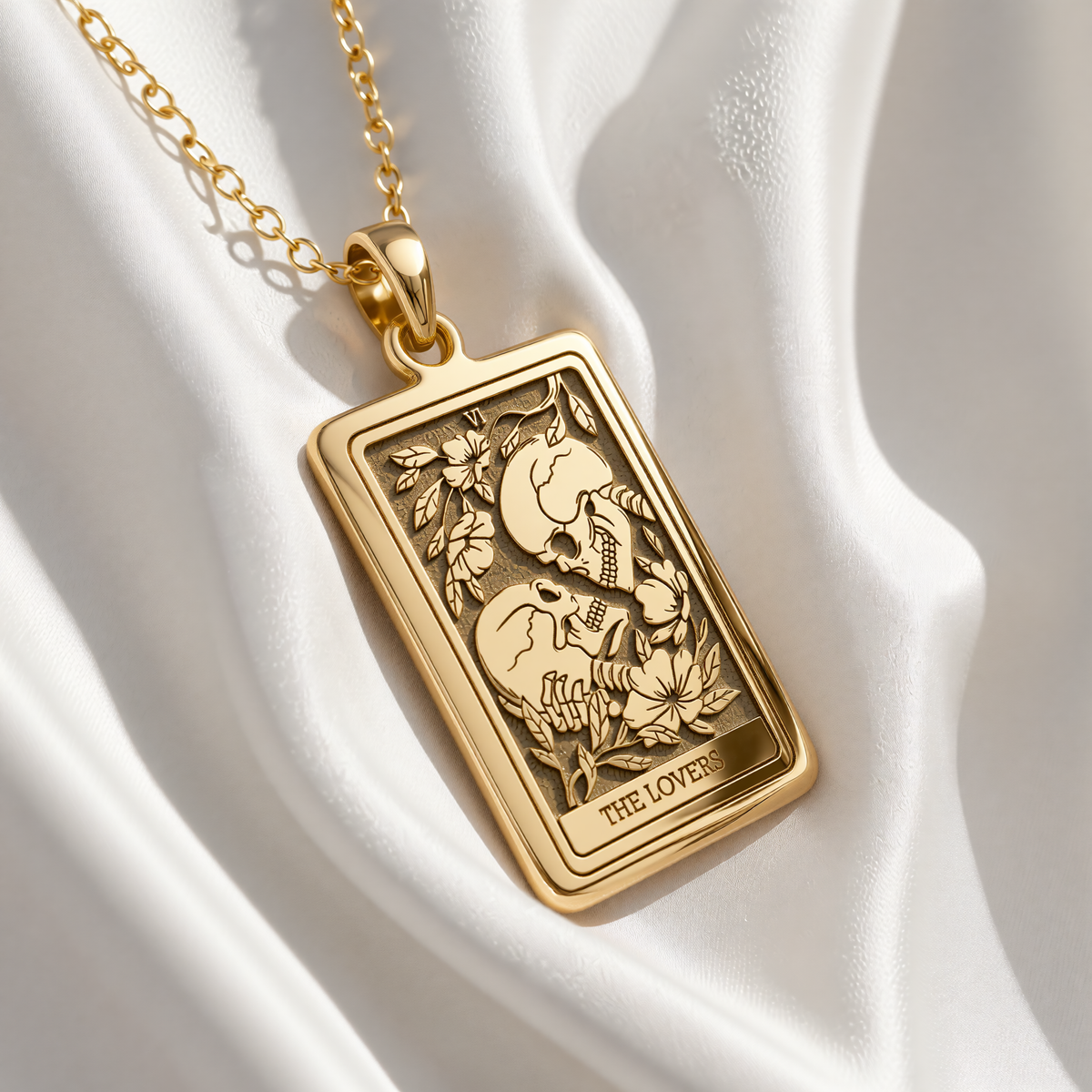 Skull Lovers Tarot Necklace pendant in gold plated finish, front view of rectangular medallion with engraved The Lovers tarot card design.