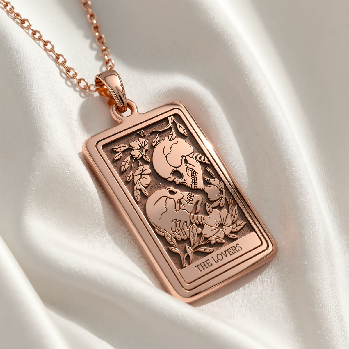 Skull Lovers Tarot Necklace rose gold plated rectangular pendant with two interlocking skulls entwined by floral vines engraved THE LOVERS