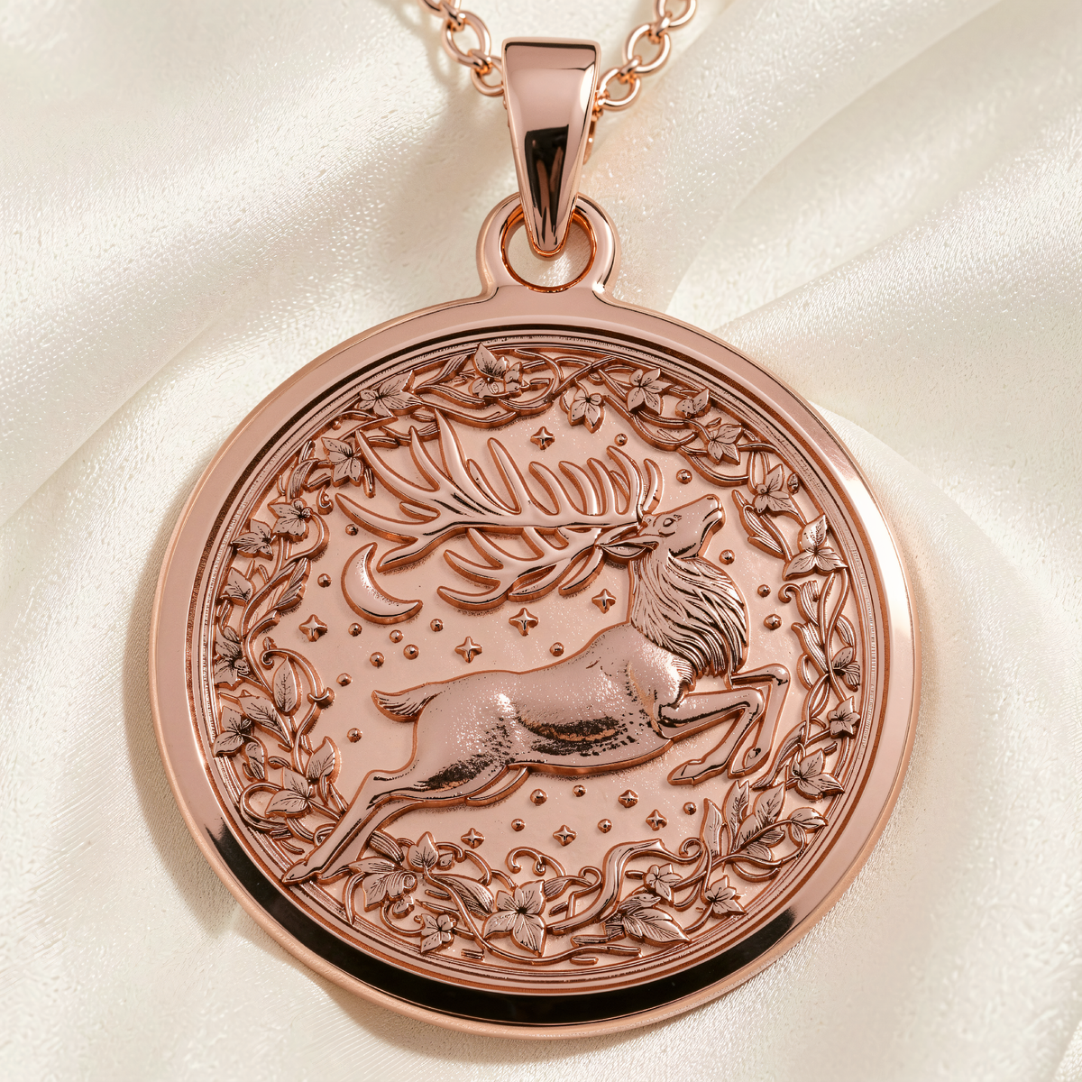Rose gold plated round pendant necklace featuring an engraved stag leaping amid floral vines, stars and a crescent moon.