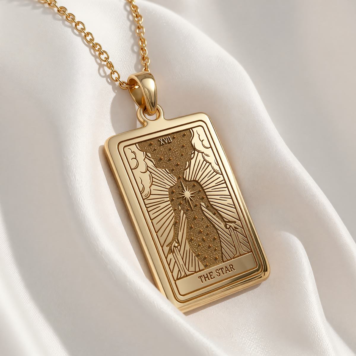 Star Tarot Necklace pendant in gold plated finish. Rectangular design shows a robed figure pouring water beneath stars with radiating light.