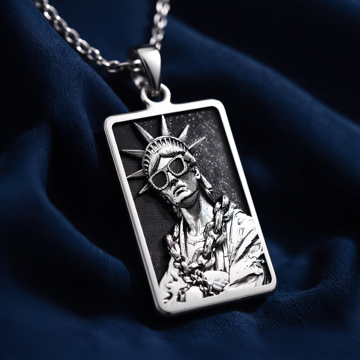 Silver pendant featuring a detailed Statue of Liberty design with an urban art motif. The pendant has a polished surface finish and is shown from a slight angle, highlighting the intricate details of the statue.