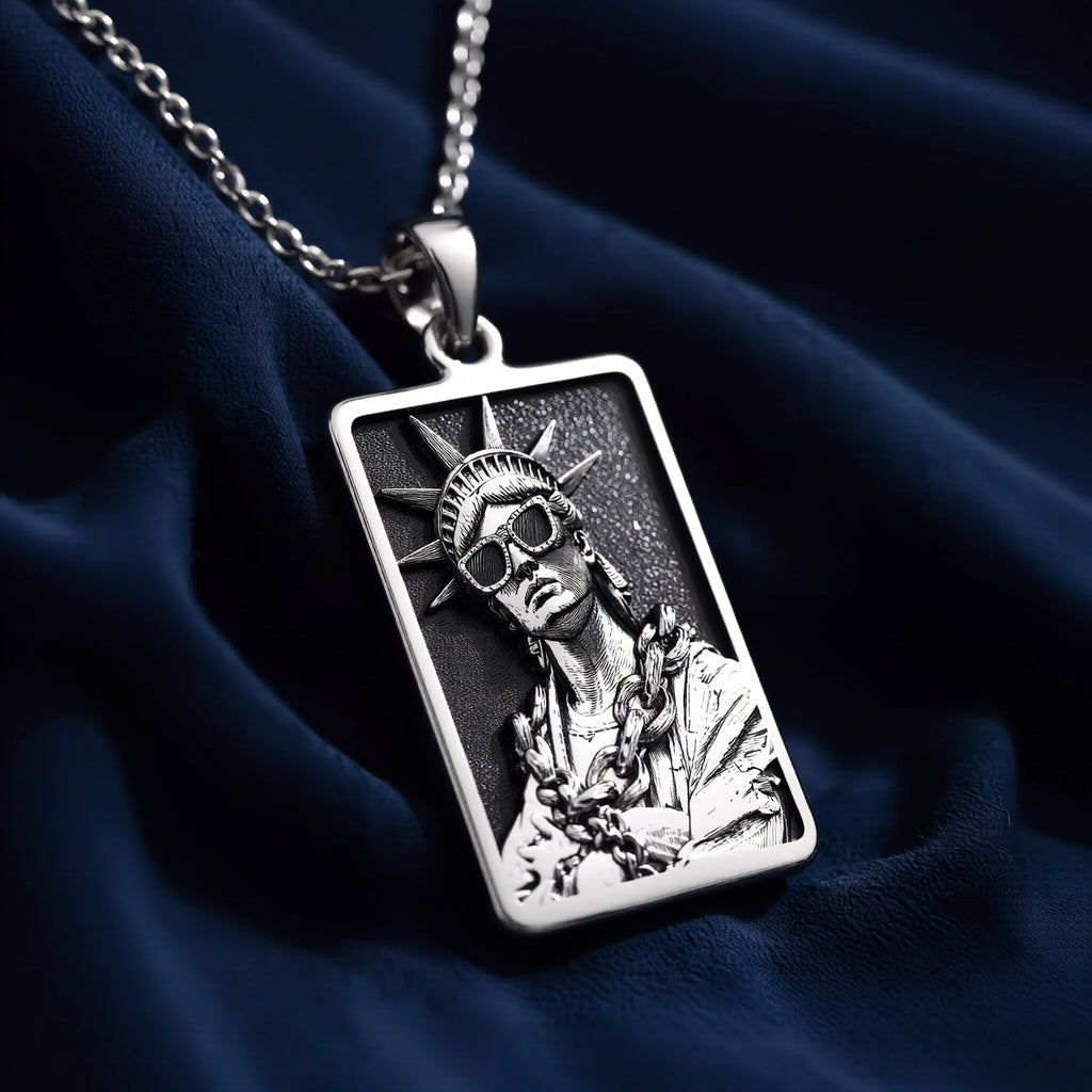 Silver plated rectangular pendant featuring a detailed classical figure with a crown motif and draped fabric. The pendant is attached to a silver chain and shown in an overhead view. - View 5