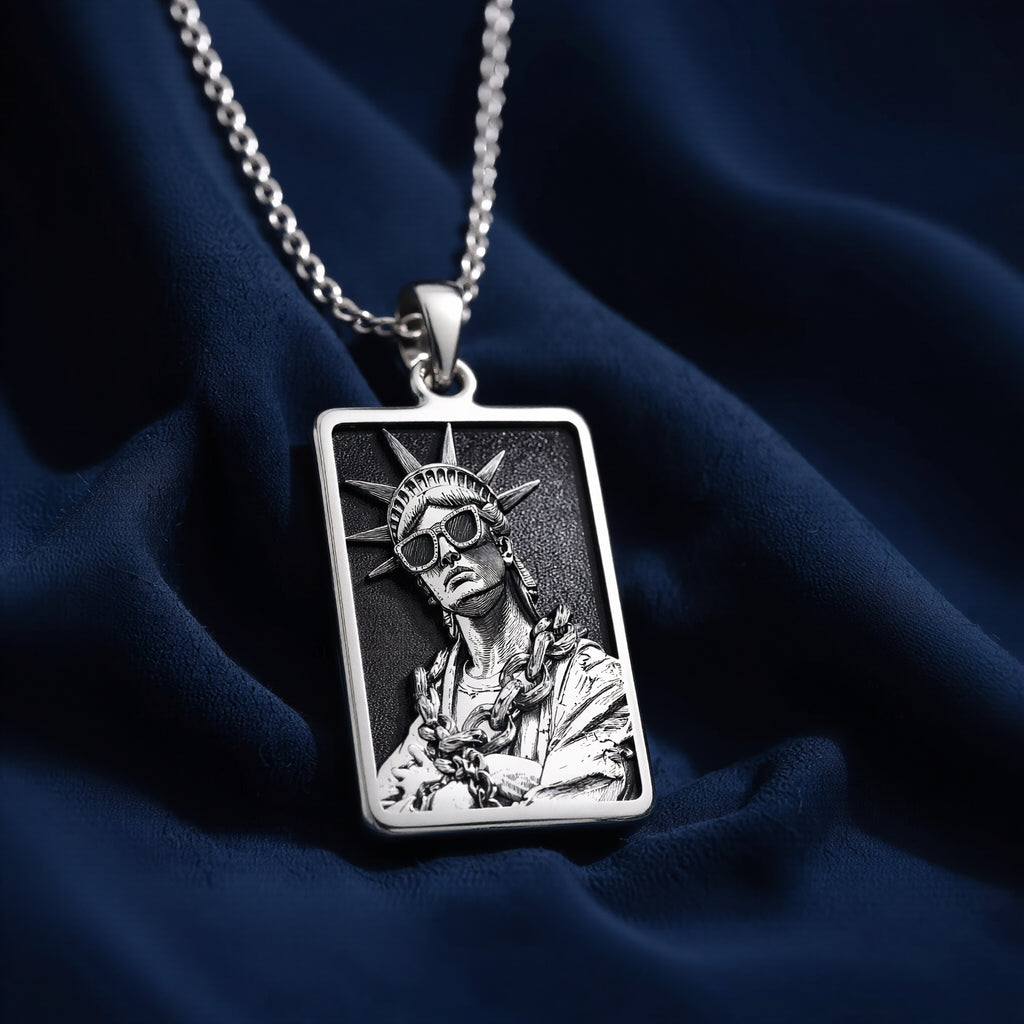 Silver plated rectangular pendant featuring a detailed classical figure with a crown motif and draped fabric. The pendant is attached to a silver chain and shown in an overhead view. - View 6