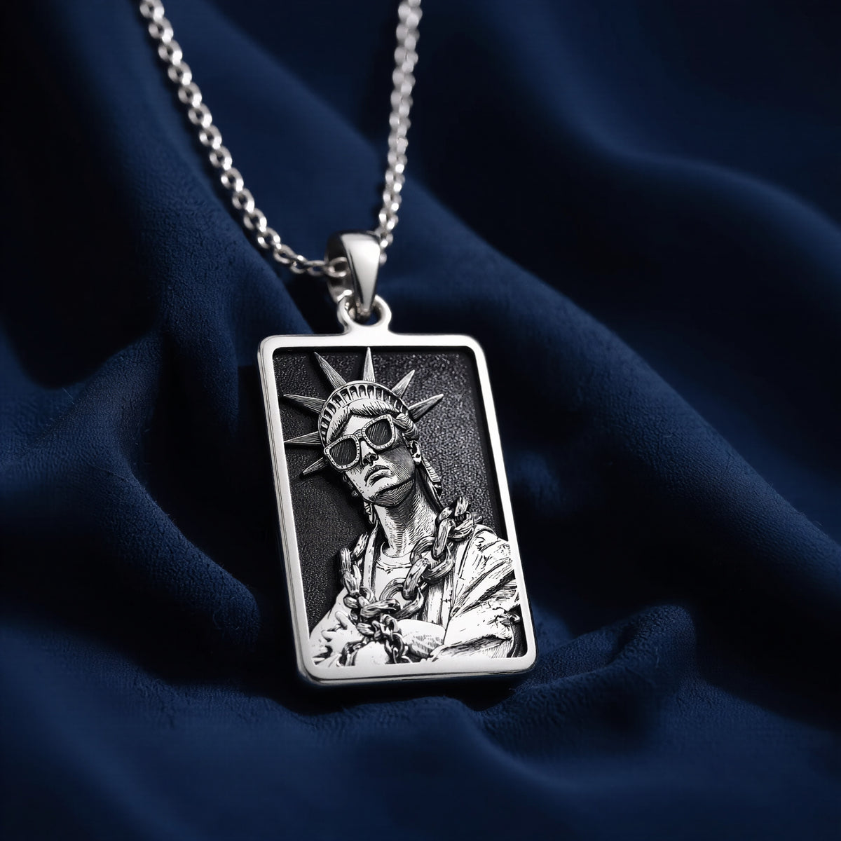 Silver plated rectangular pendant featuring a detailed classical figure with a crown motif and draped fabric. The pendant is attached to a silver chain and shown in an overhead view. - View 6