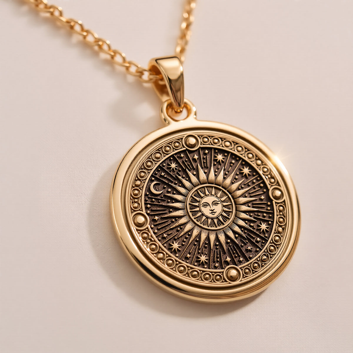 14K Solid Gold Sun Necklace pendant: close-up of engraved sun face with radiating rays, stars and crescent moon inside beaded border.