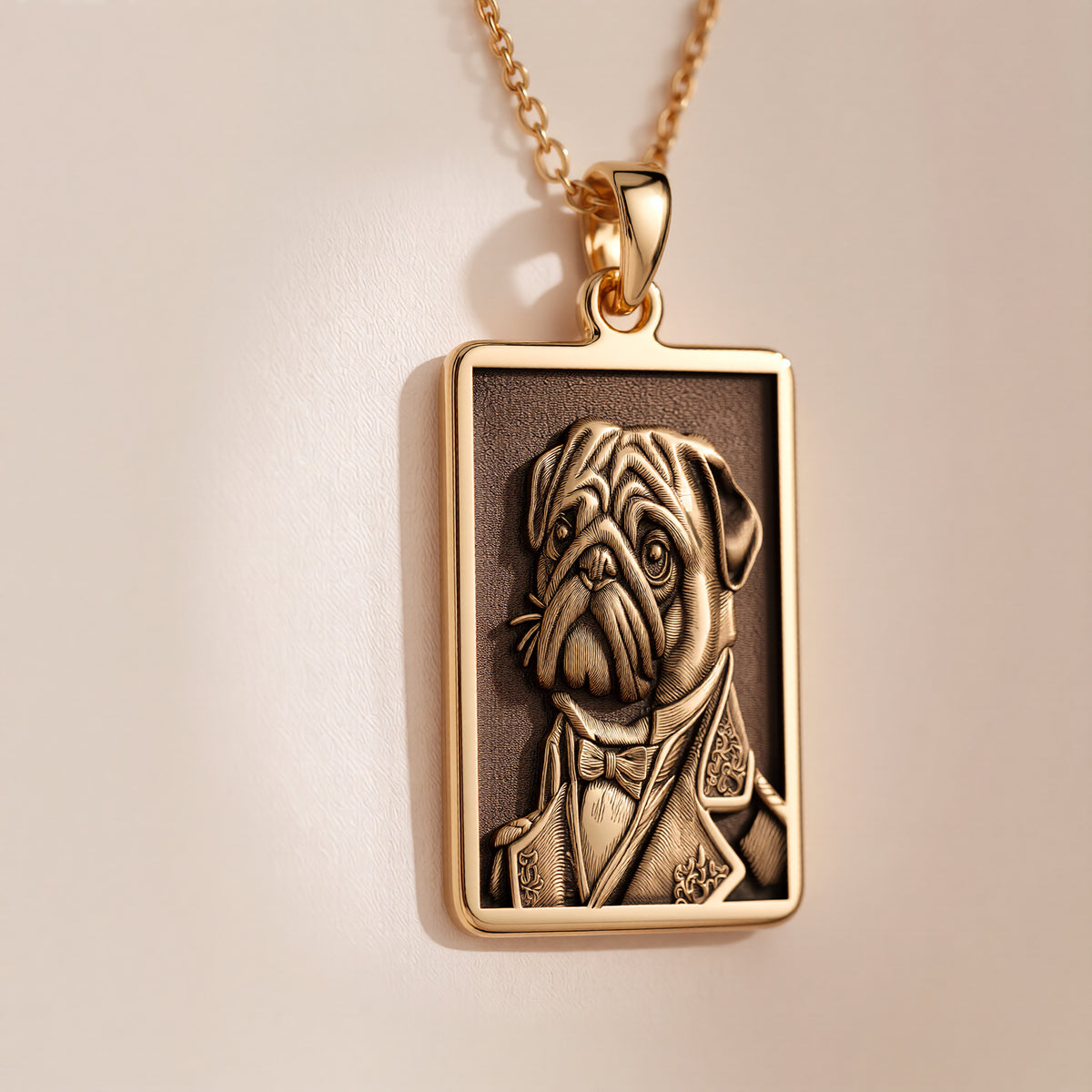 A rectangular 14K gold plated pendant necklace featuring a detailed laser engraving of a distinguished Pug dog in a Victorian suit.