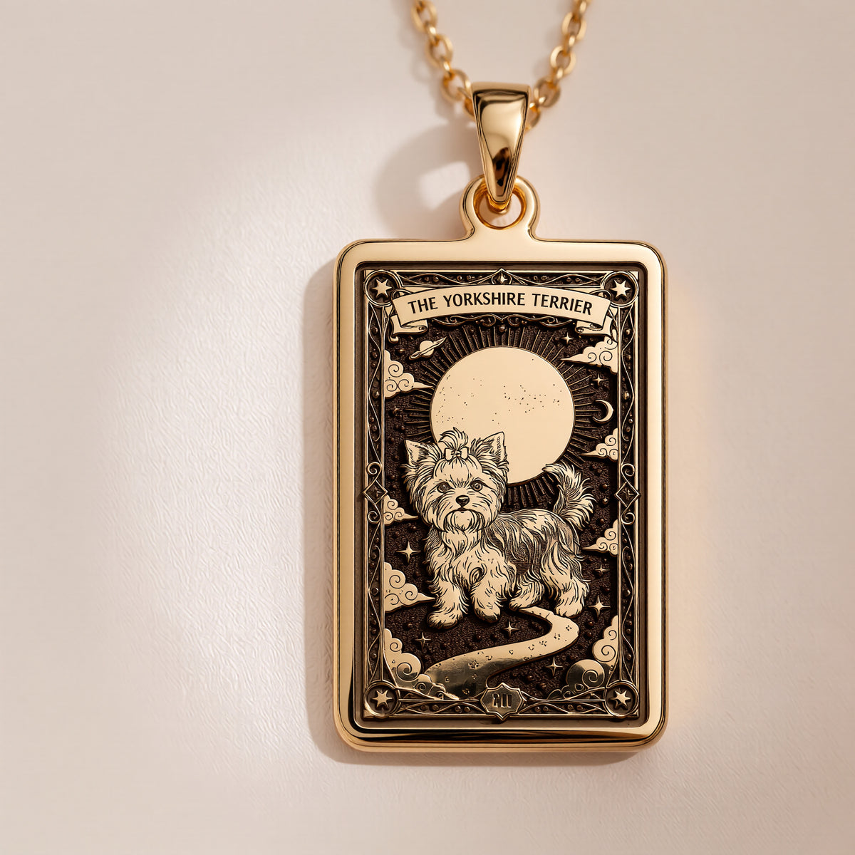 An heirloom-quality 14K solid gold Yorkshire Terrier tarot pendant. The art shows the sassy dog under the moon, symbolizing its big spirit, a precious dog mom gift.
